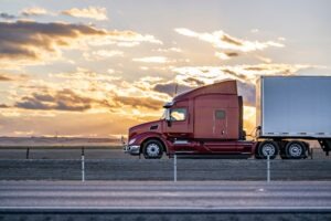 A truck drives along Interstate 90 in Sioux Falls at sunset.
