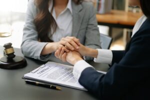 A compassionate lawyer comforts a personal injury client.