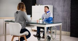 A truck accident victim in a wheelchair with a neck brace and an arm sling discussing his case with an experienced truck accident lawyer in Mitchell.